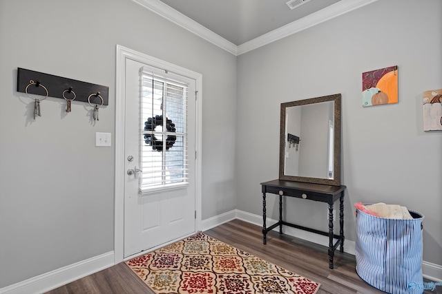 foyer featuring hardwood / wood-style flooring, crown molding, and a healthy amount of sunlight