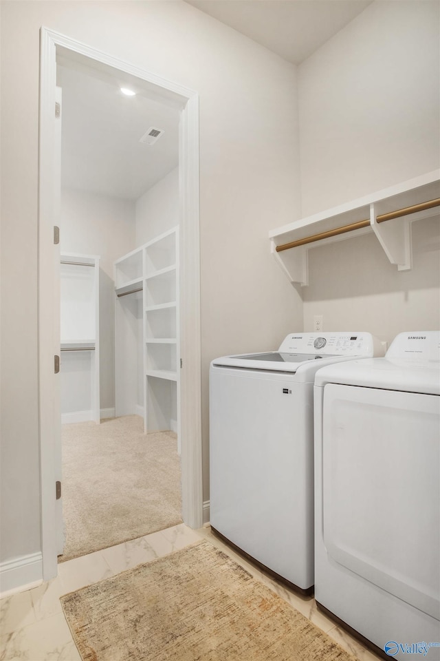 106 Kite Cir, Madison, AL 35756 - laundry room with washing machine and clothes dryer, light marble finish floors, and light carpet