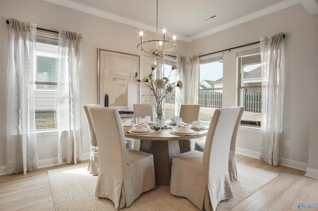 106 Kite Cir, Madison, AL 35756 - dining area featuring ornamental molding, light wood finished floors, and a chandelier