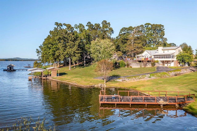 dock area with a water view and a yard