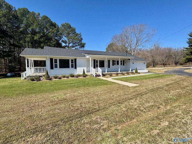 single story home with covered porch and a front yard