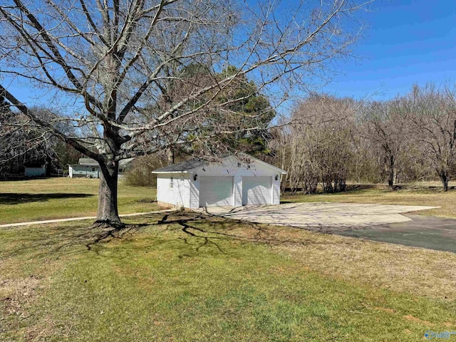 view of yard with a detached garage and an outdoor structure