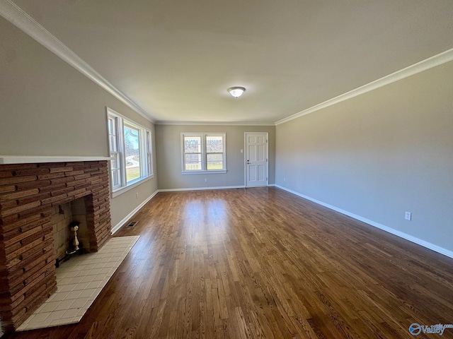 unfurnished living room with crown molding, dark wood finished floors, and baseboards