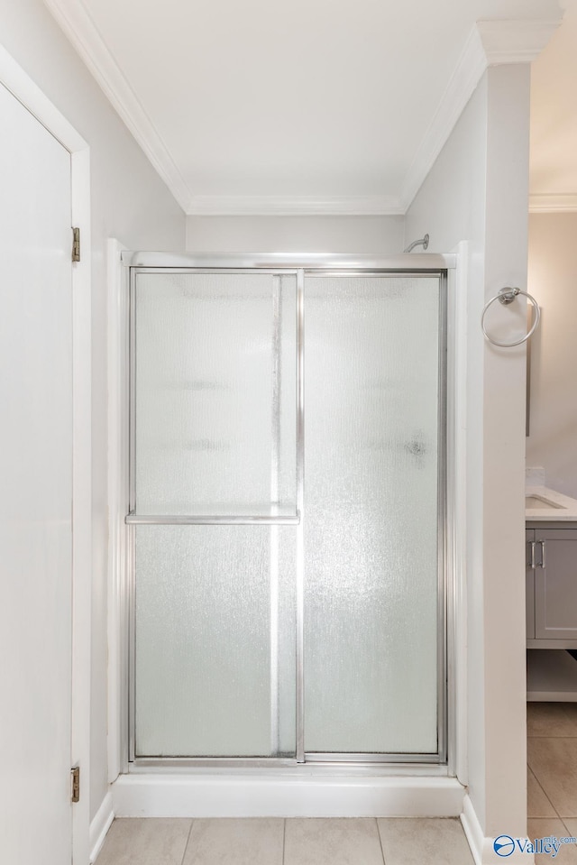 full bath featuring tile patterned floors, a shower stall, and crown molding