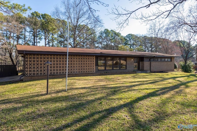 rear view of house featuring a yard