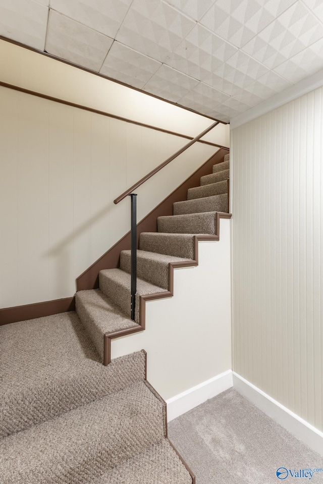 stairway with baseboards and carpet