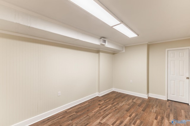 finished below grade area with visible vents, baseboards, and dark wood-style flooring