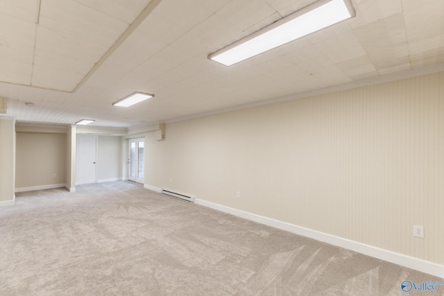 basement with a baseboard radiator, baseboards, and light colored carpet