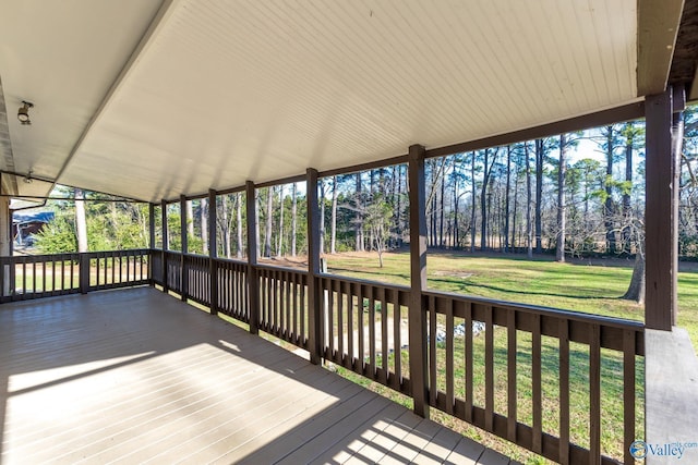 wooden terrace featuring a lawn