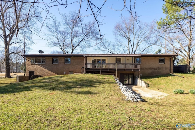 back of house with crawl space, brick siding, a deck, and a lawn