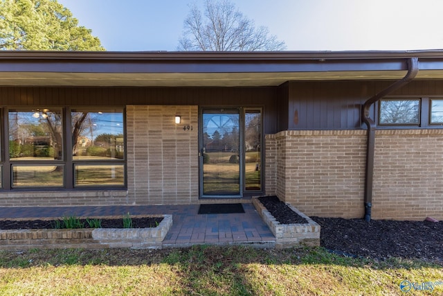 property entrance with brick siding