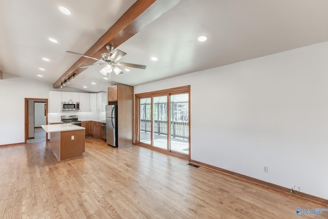 kitchen with visible vents, lofted ceiling with beams, light countertops, appliances with stainless steel finishes, and light wood-type flooring