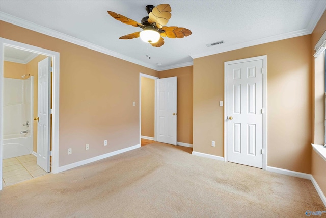 unfurnished bedroom with ceiling fan, ensuite bath, ornamental molding, and light carpet