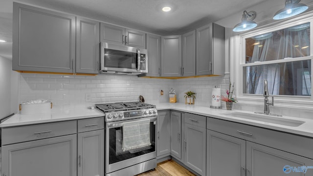 111 Althea St, Gadsden, AL 35904 - kitchen with appliances with stainless steel finishes, gray cabinetry, a sink, and light countertops