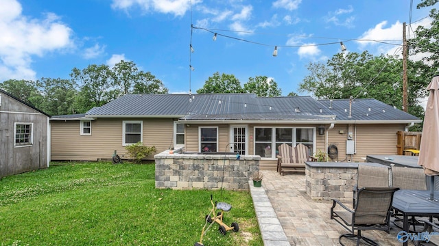 111 Althea St, Gadsden, AL 35904 - rear view of property with a patio area, a covered hot tub, and metal roof