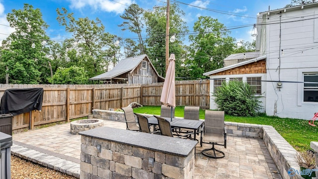111 Althea St, Gadsden, AL 35904 - fenced backyard featuring a fire pit, a patio, and outdoor dining space