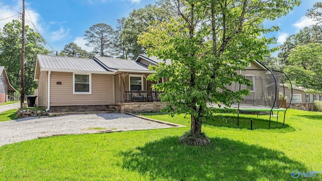 111 Althea St, Gadsden, AL 35904 - view of front facade featuring a trampoline, a front lawn, a porch, and metal roof