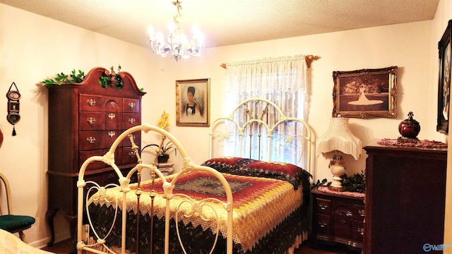 bedroom with a textured ceiling and an inviting chandelier