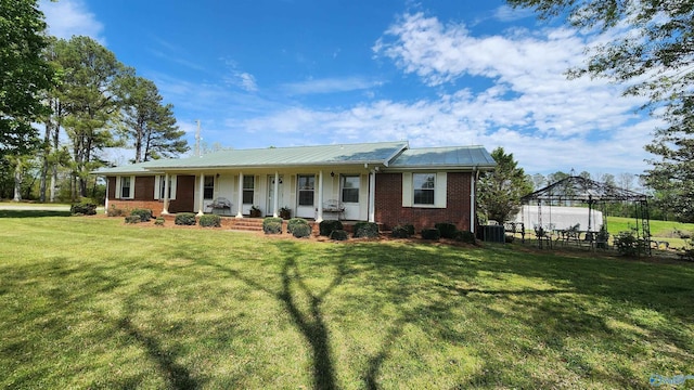 view of front of home featuring a gazebo, central air condition unit, and a front yard