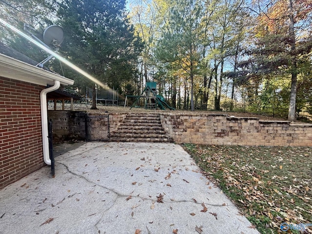 view of yard with a playground and a patio