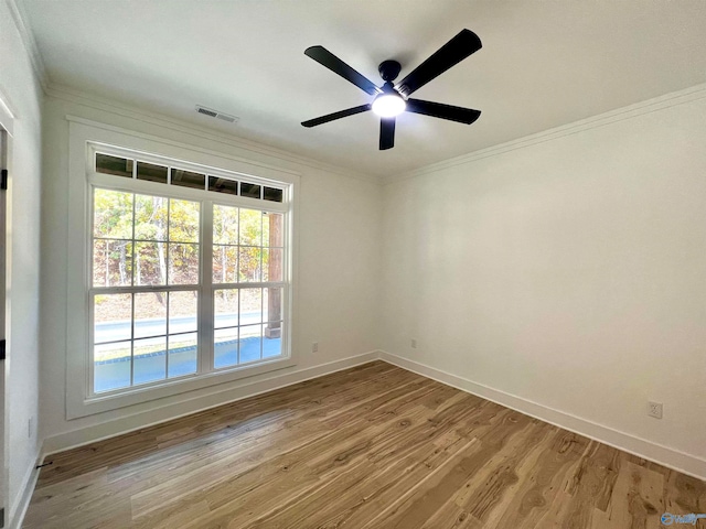 unfurnished room with hardwood / wood-style floors, crown molding, and ceiling fan