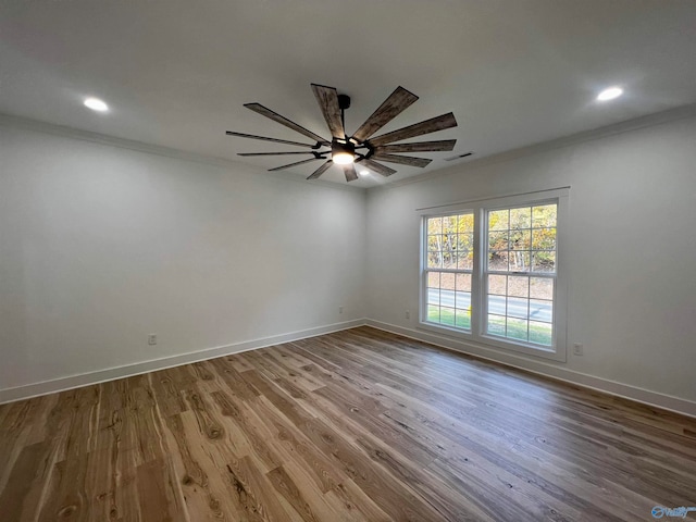 spare room featuring ornamental molding, hardwood / wood-style floors, and ceiling fan