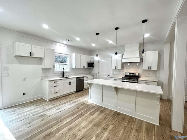 1921 Patterson St, Guntersville, AL 35976 - kitchen with custom range hood, appliances with stainless steel finishes, a sink, ornamental molding, and tasteful backsplash