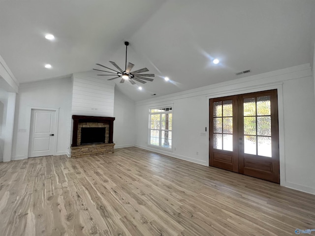 1921 Patterson St, Guntersville, AL 35976 - unfurnished living room featuring ceiling fan, french doors, light wood-style floors, a stone fireplace, and baseboards
