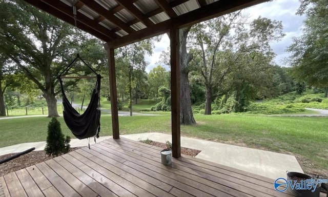 wooden terrace featuring a lawn