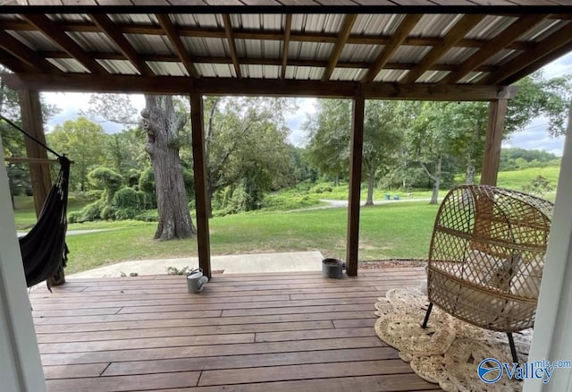 wooden terrace featuring a yard