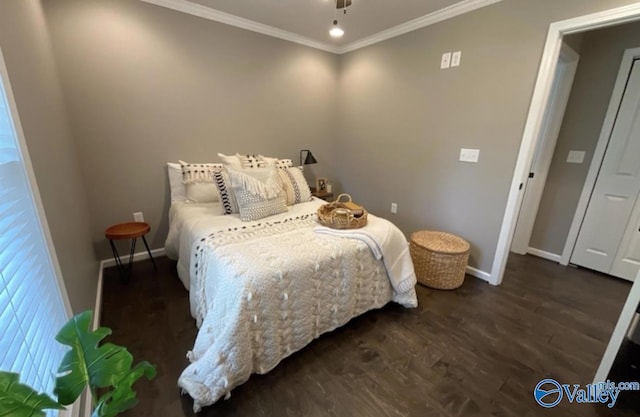 bedroom with crown molding, dark wood finished floors, and baseboards