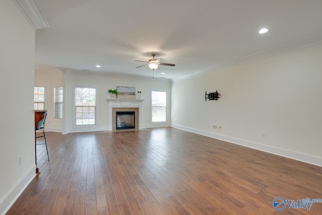 unfurnished living room with ornamental molding, dark wood finished floors, and baseboards