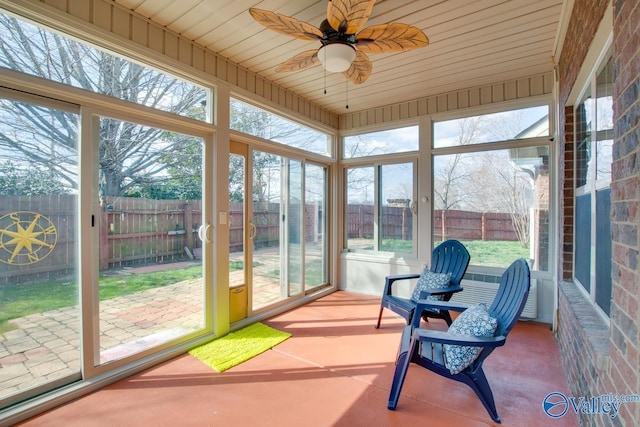 sunroom featuring wooden ceiling and ceiling fan