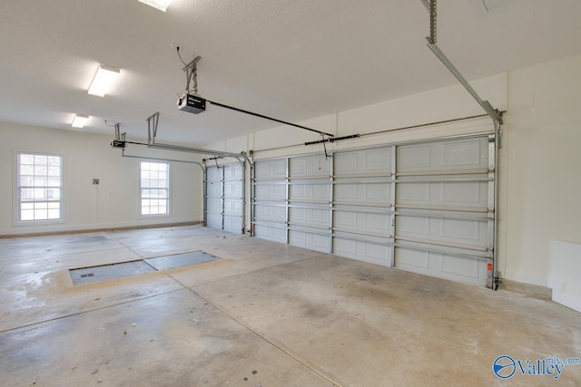 garage featuring a garage door opener and baseboards