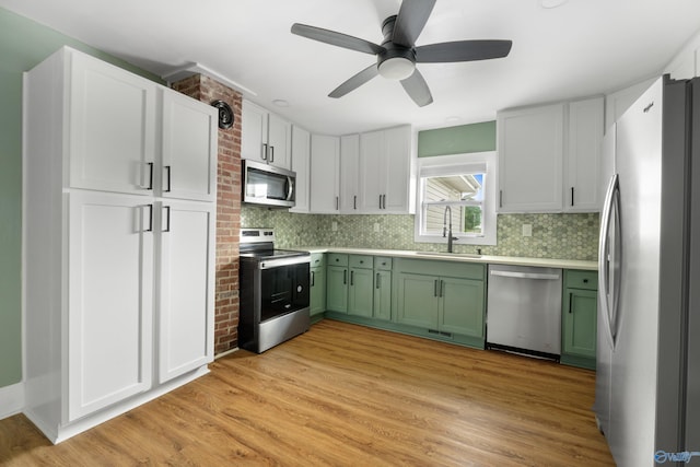 265 Dorning Rd, Harvest, AL 35749 - kitchen with appliances with stainless steel finishes, green cabinets, a sink, and tasteful backsplash