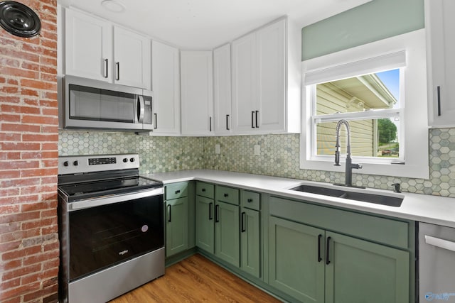 265 Dorning Rd, Harvest, AL 35749 - kitchen featuring stainless steel appliances, green cabinetry, a sink, light countertops, and white cabinetry