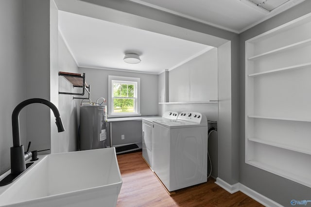265 Dorning Rd, Harvest, AL 35749 - washroom featuring washing machine and clothes dryer, electric water heater, dark wood-style flooring, crown molding, and built in shelves
