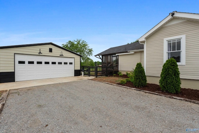 265 Dorning Rd, Harvest, AL 35749 - view of side of property featuring an outdoor structure, gravel driveway, a garage, and roof with shingles