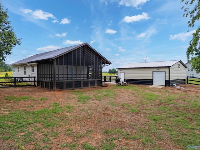 265 Dorning Rd, Harvest, AL 35749 - back of house featuring a sunroom, an outbuilding, and a garage