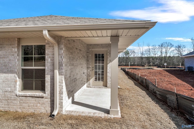 view of exterior entry with a patio area