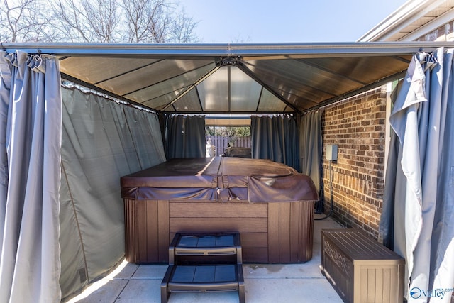 view of patio / terrace with a gazebo and a hot tub