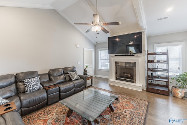 living room with ceiling fan, lofted ceiling, a healthy amount of sunlight, and dark hardwood / wood-style flooring