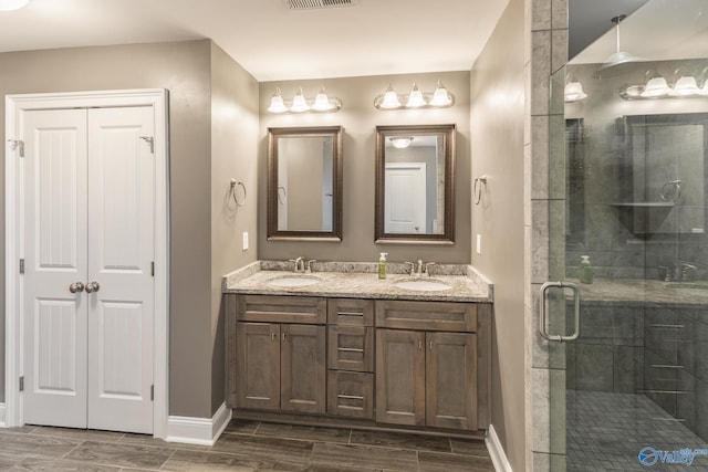 bathroom with vanity and a shower with shower door