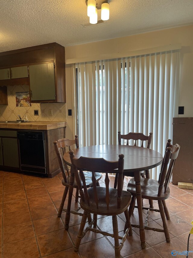 kitchen featuring sink, decorative backsplash, stainless steel range with electric cooktop, and exhaust hood