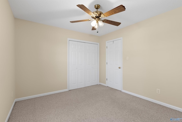 unfurnished bedroom featuring ceiling fan, a closet, and carpet floors