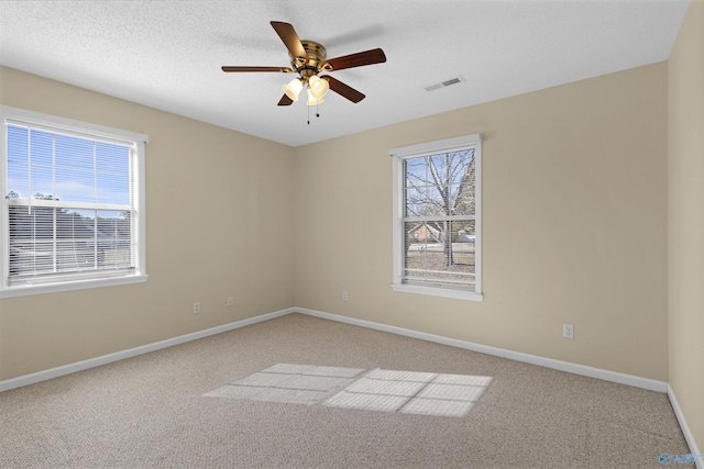empty room featuring ceiling fan and carpet floors