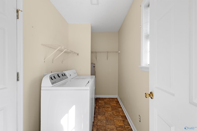 washroom featuring washer and clothes dryer
