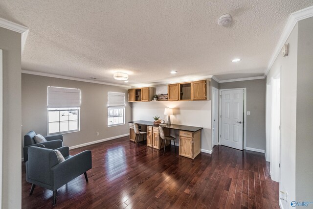 office space with dark wood-style flooring, crown molding, built in desk, and baseboards