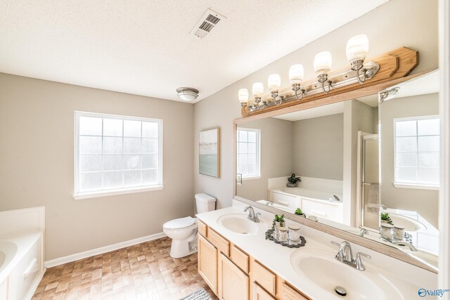 full bathroom with visible vents, a sink, and a garden tub