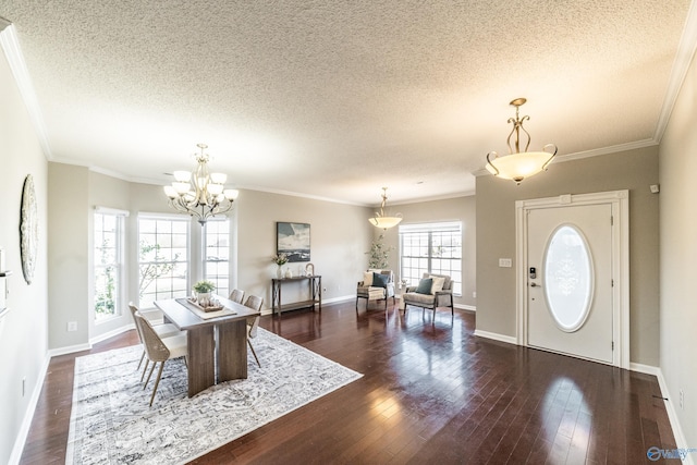 entrance foyer with ornamental molding, a notable chandelier, and hardwood / wood-style flooring